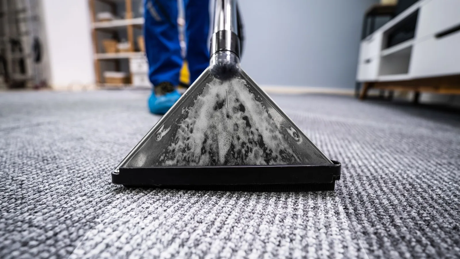 Carpet extraction wand removing soil from carpet