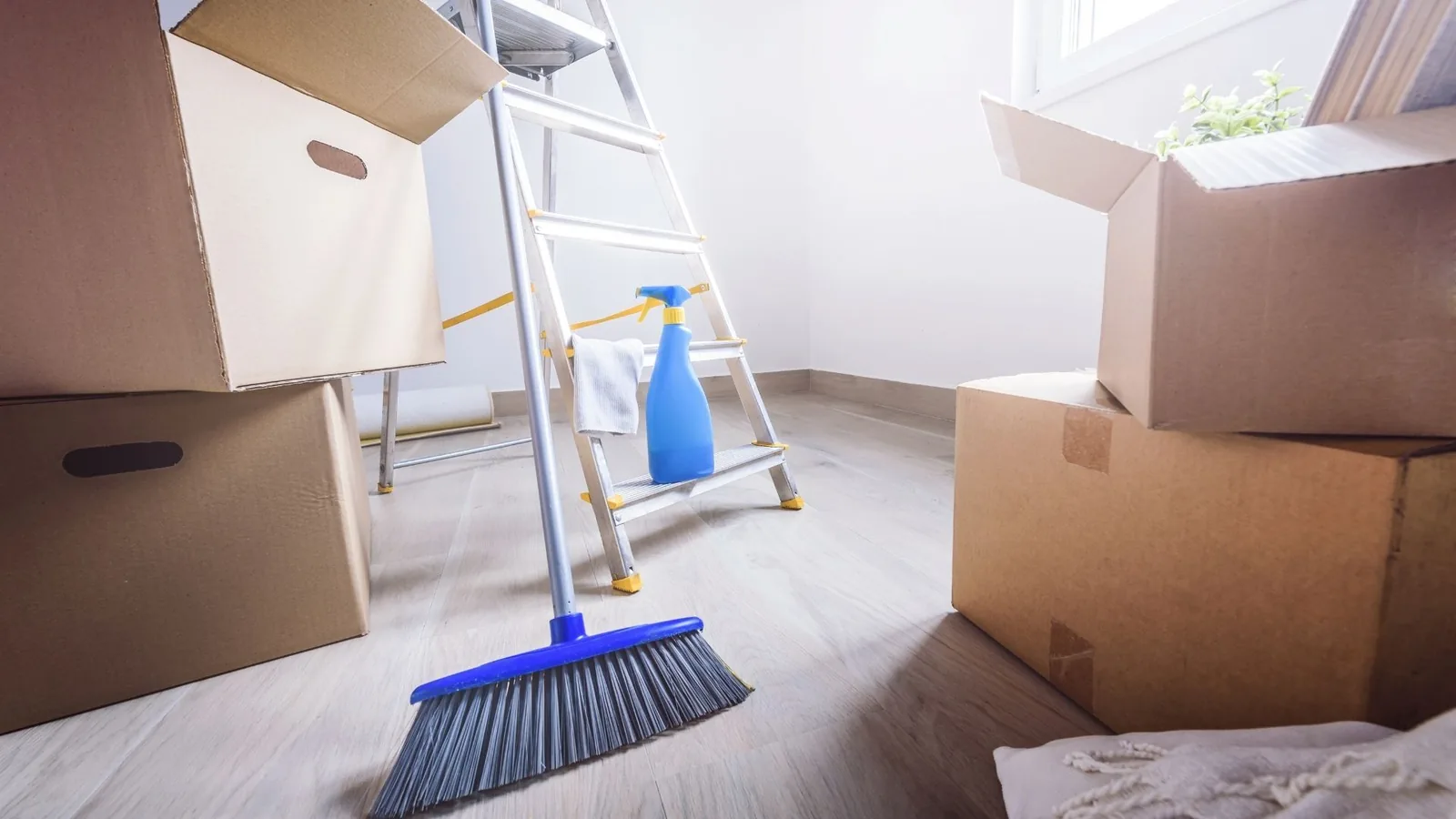 Boxes and cleaning tools during move-in cleaning prep